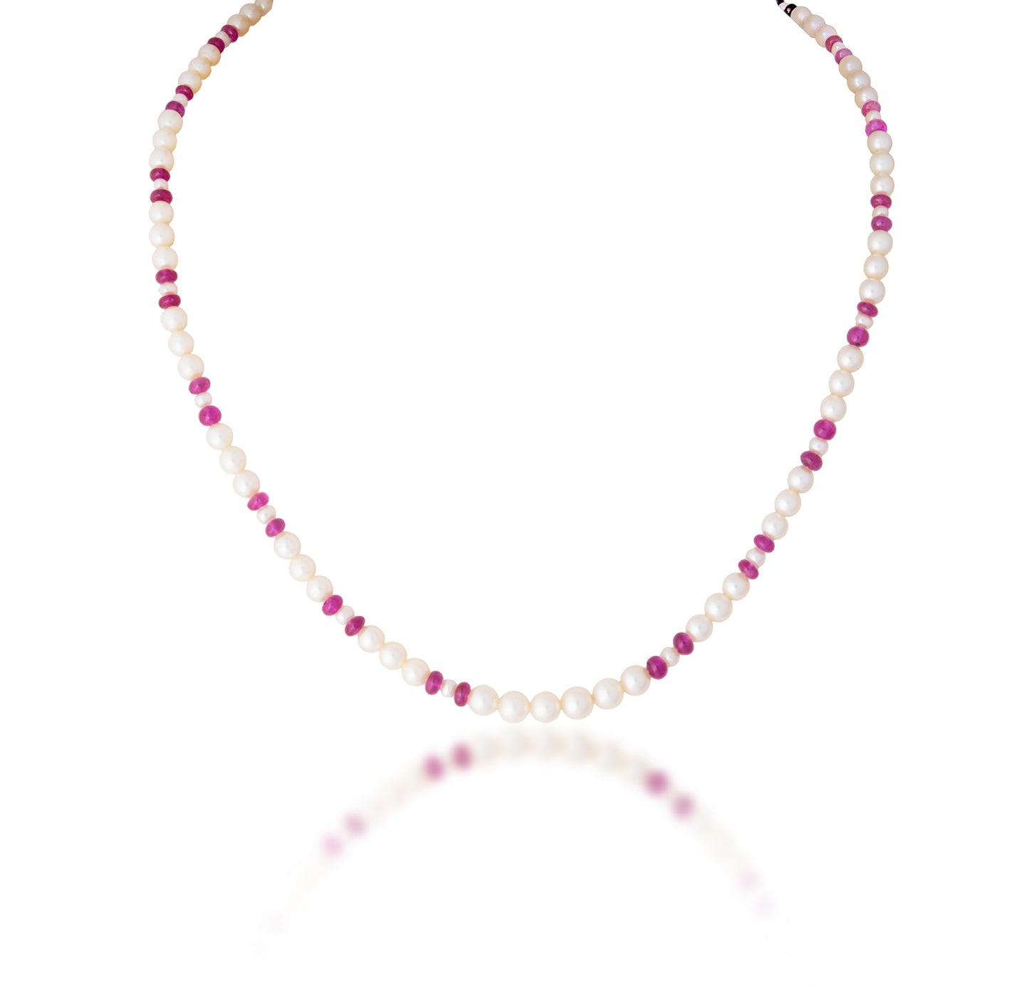 A STRAND OF CULTURED PEARL & RUBY