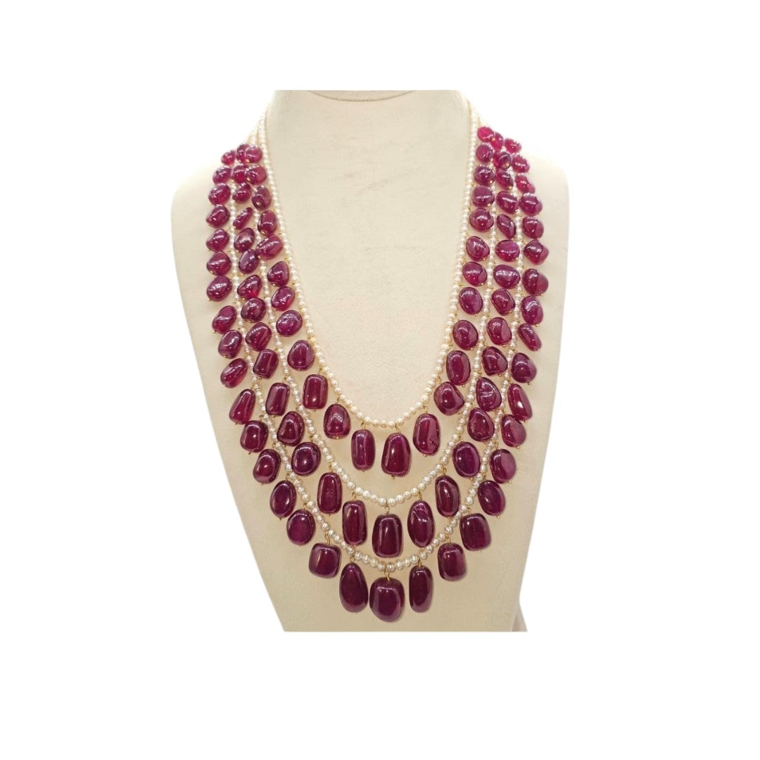 A STRAND OF 3 LINE CULTURED PEARL CUSTOM CUT WITH AFRICAN RUBY SHAPE