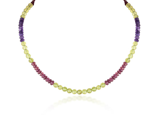 A STRAND OF MULTI PERIDOT GARNET & AMETHEST